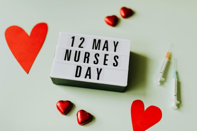 A tribute to Nurses Day with a lightbox message, hearts, and syringes on a pastel background.
