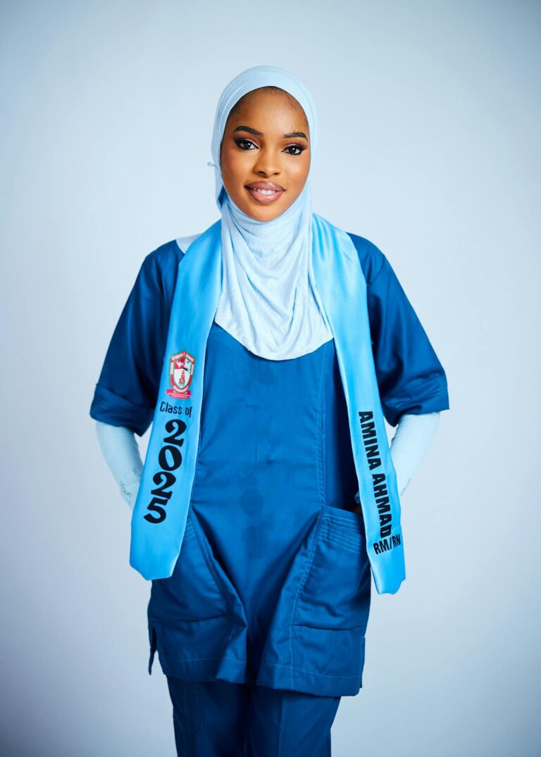 Young female medical graduate wearing scrubs and hijab, Class of 2025 sash.